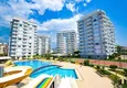 Buy 3+1 linear apartment with furniture, sea and mountain views on the beachfront - Tosmur, Alanya 1 
