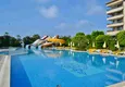 Buy 3+1 linear apartment with furniture, sea and mountain views on the beachfront - Tosmur, Alanya 8 