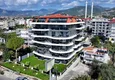 Buy 1+1 apartment overlooking the sea and the fortress on the beachfront in Kestel 2 
