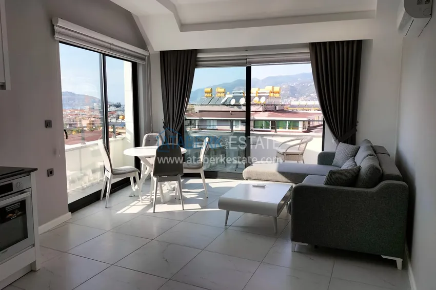 Purchase 1+1 penthouse with sea and mountain views in Alanya Tosmur B21 district 1