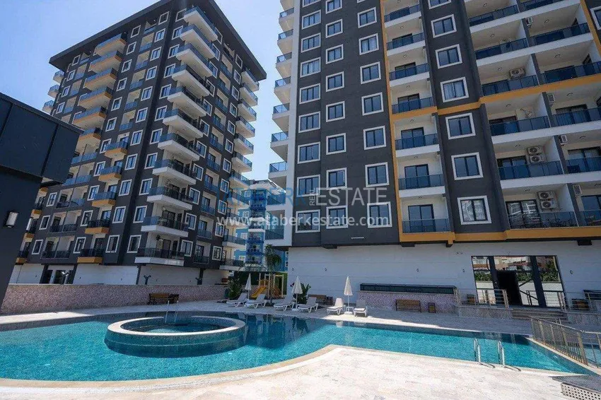 Finished two-bedroom apartment in a complex under completion in Mahmutlar 3 
